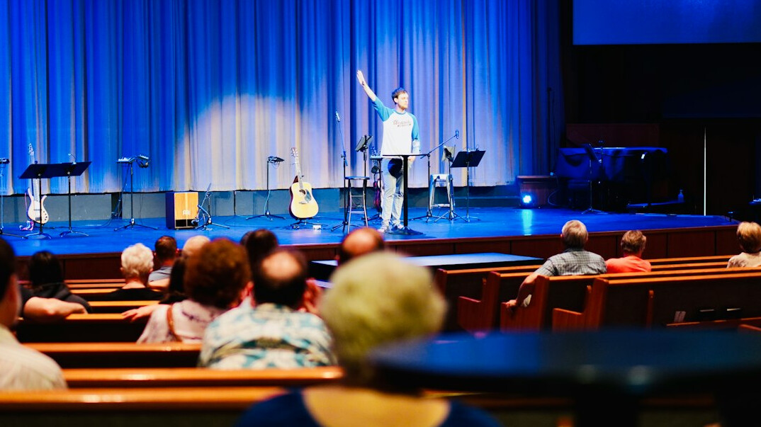 Speaker presenting on stage to an audience