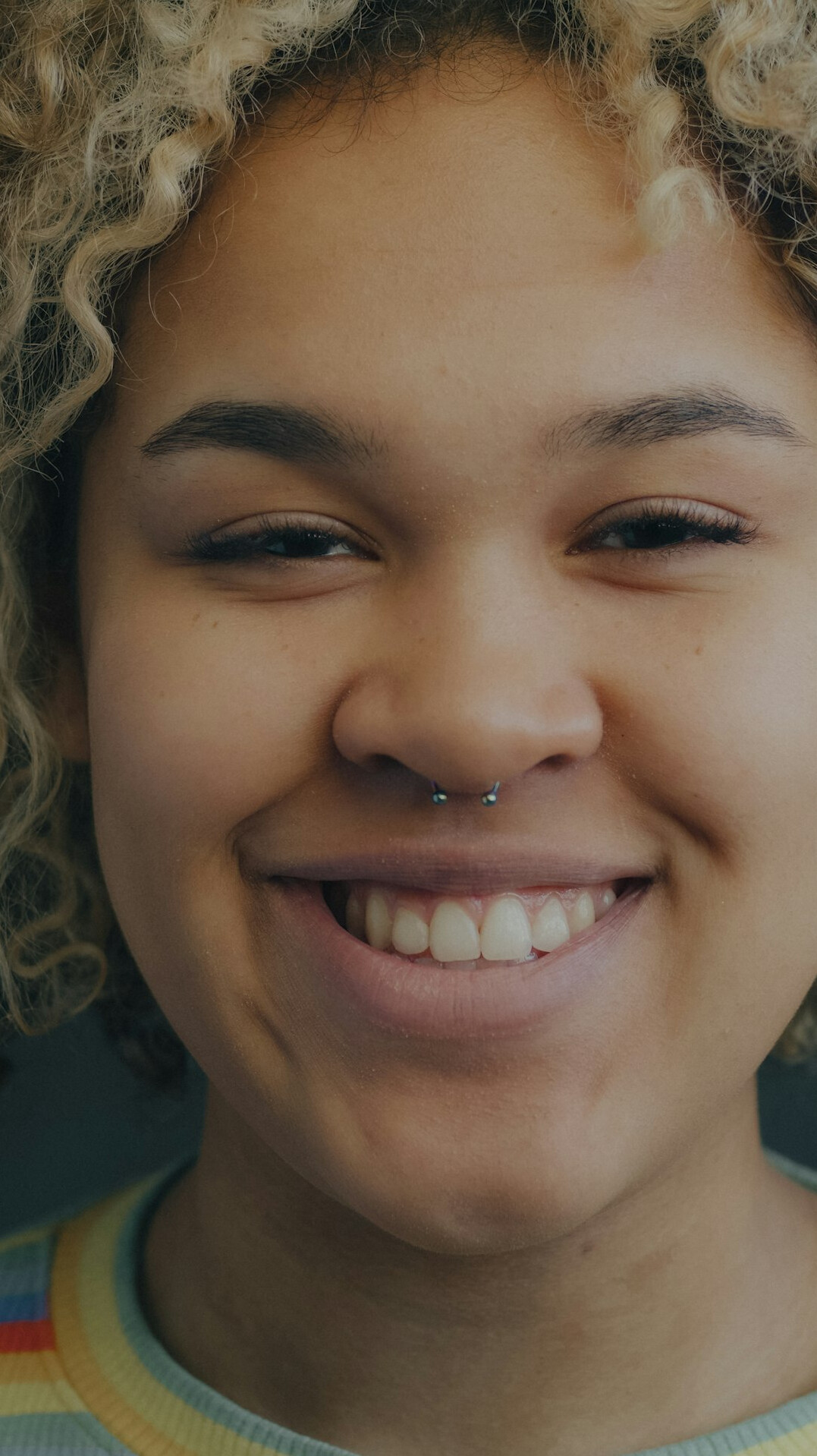 Portrait of a smiling young woman with curly hair